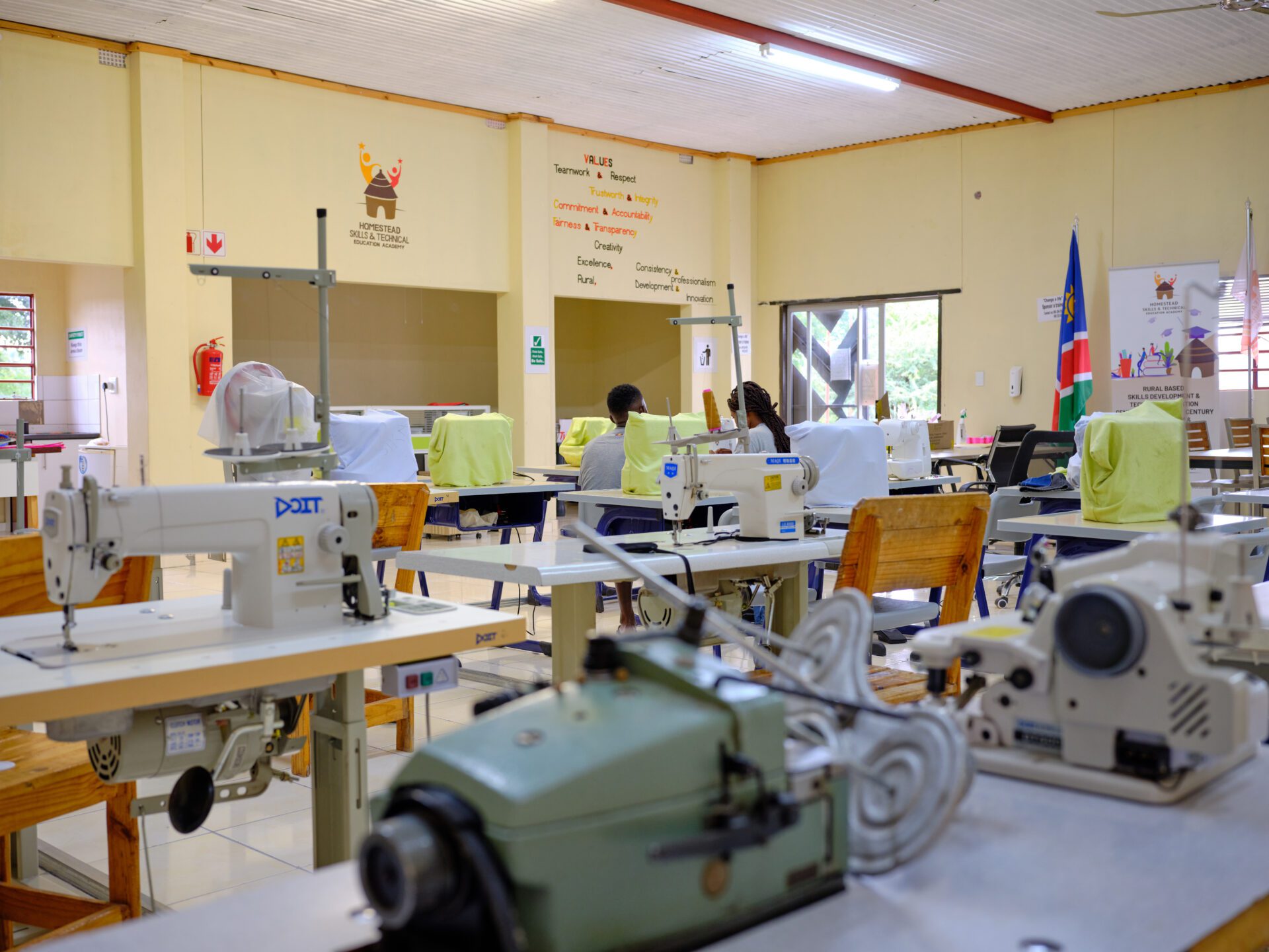 a woman and men working on a sewing machine