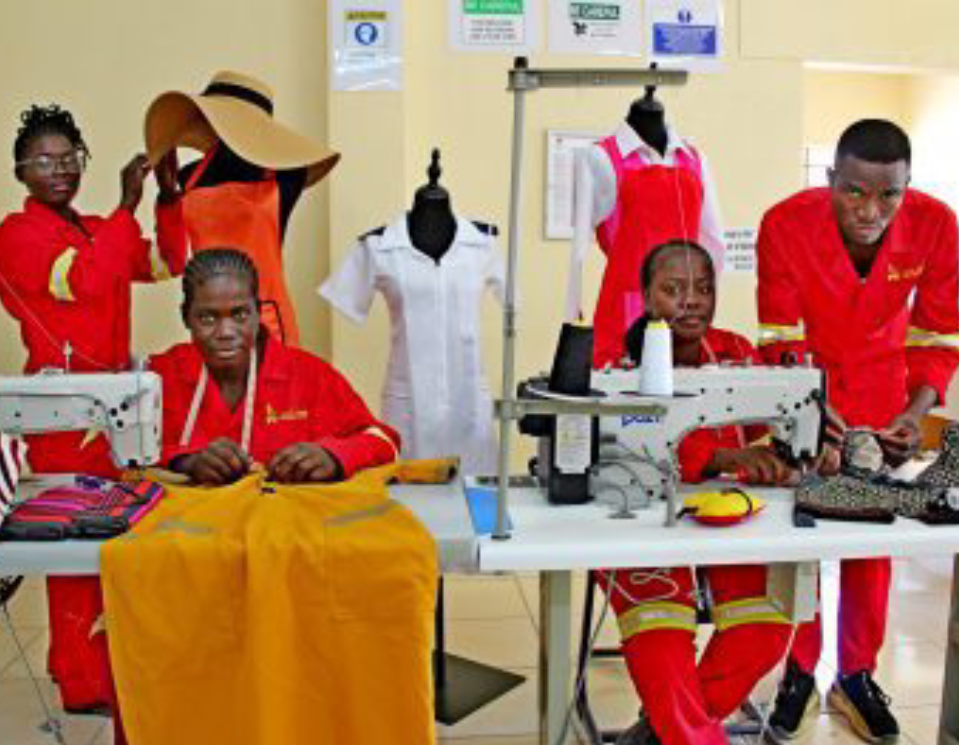 a group of people working on sewing machines