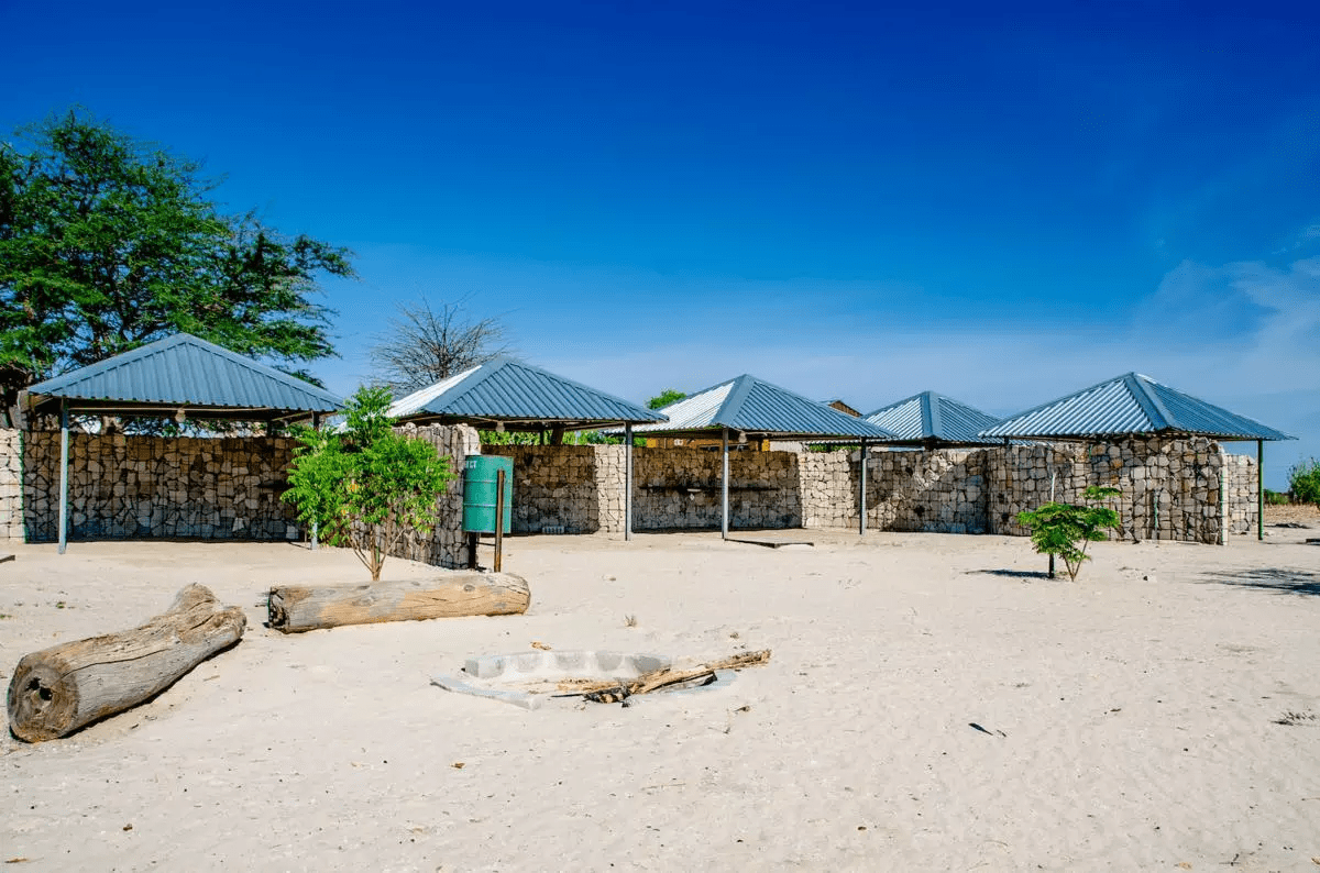 a small building with a roof and a tree